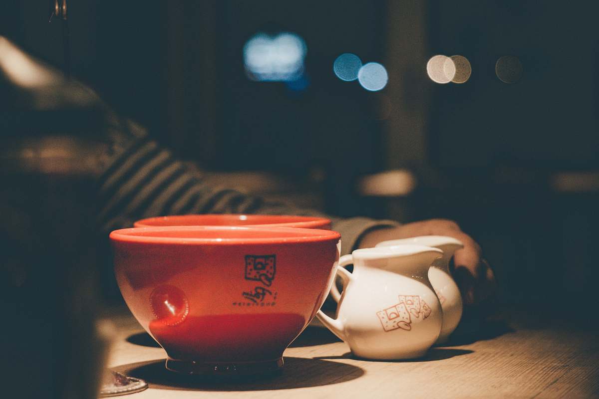le pain quotidien selective focus photography of two red ceramic bowls near two white ceramic pitchers united states
